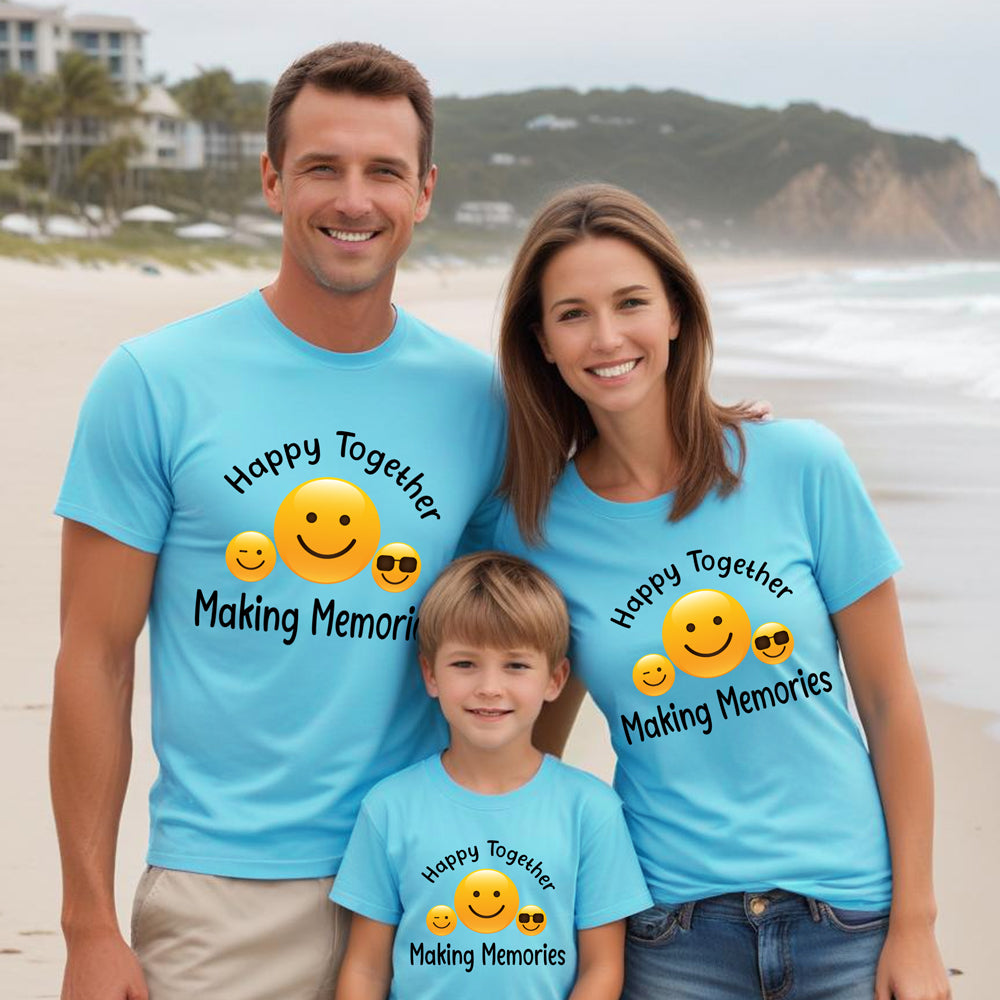 Family of three wearing matching blue t-shirts with a beach background
