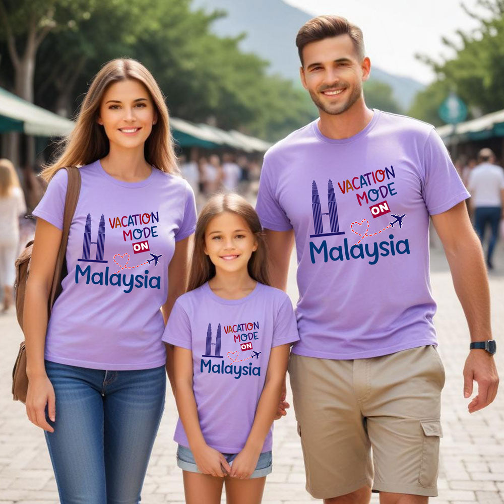 Family of three wearing matching purple t-shirts with 'Vacation Mode ON Malaysia' text.
