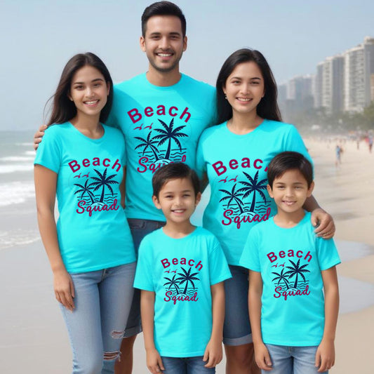 Family of five wearing matching blue t-shirts with 'Beach Squad' text and palm tree graphics on a beach.
