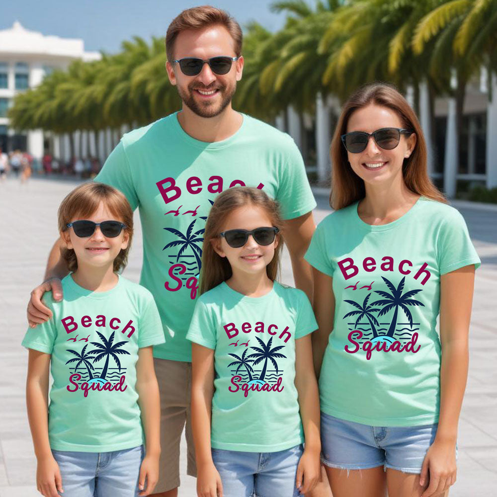Family wearing matching teal t-shirts with 'Beach Squad' text and palm tree graphics.