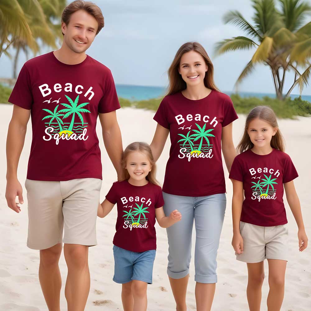 Family of four wearing matching 'Beach Squad' t-shirts on a beach.