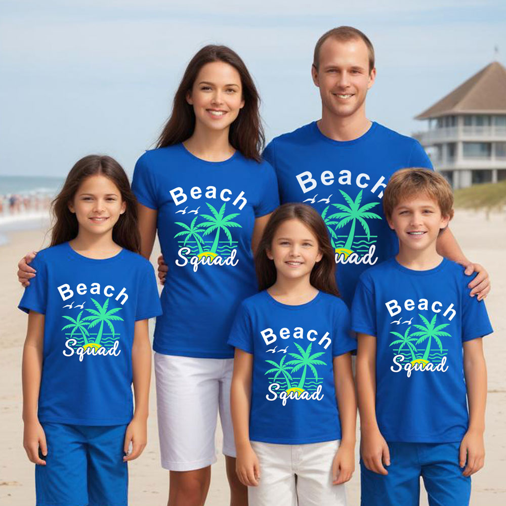 Family of five wearing matching blue 'Beach Squad' shirts on a beach.
