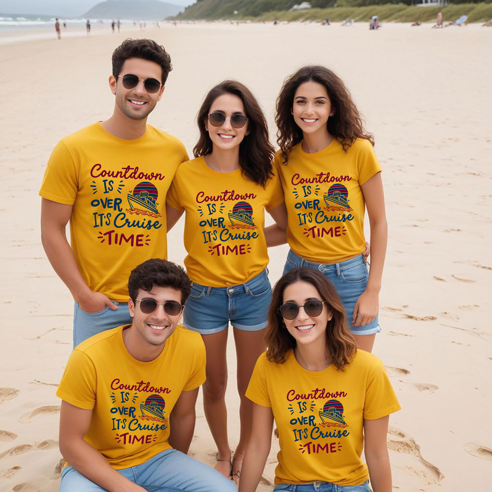 Five friends wearing matching yellow t-shirts on a beach.