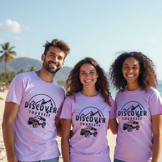 Three people wearing pink 'Discover Yourself' t-shirts on a beach.