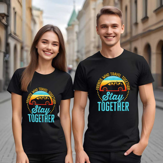 Two people wearing black t-shirts with a colorful graphic and text on a city street.