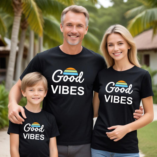 Family of three wearing 'Good Vibes' t-shirts outdoors with palm trees in the background.