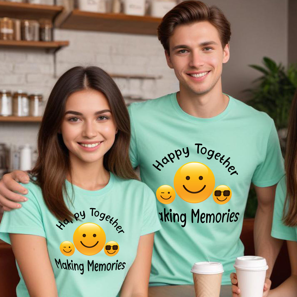 Two people wearing matching light blue t-shirts with smiley face graphics and text in a casual setting.
