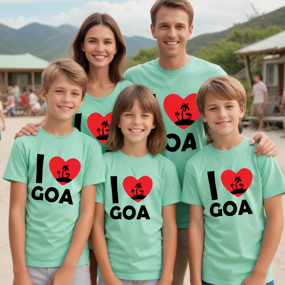Family wearing matching green t-shirts with 'I ❤️ Goa' design outdoors.