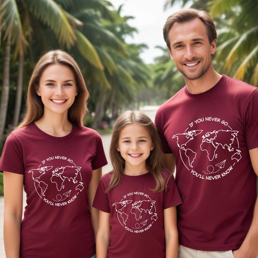 Family of three wearing matching maroon t-shirts with a world map design and text.