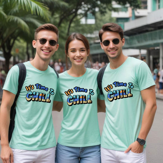 Three friends wearing matching light blue t-shirts with 'It's Time To Chill' text in an urban setting.
