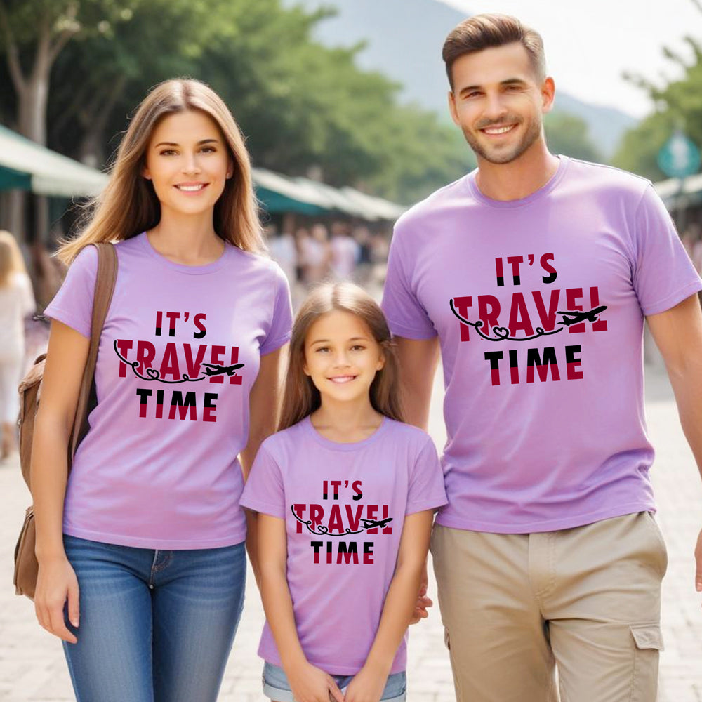 Family of three wearing matching purple t-shirts with 'It's Travel Time' text in an outdoor setting.