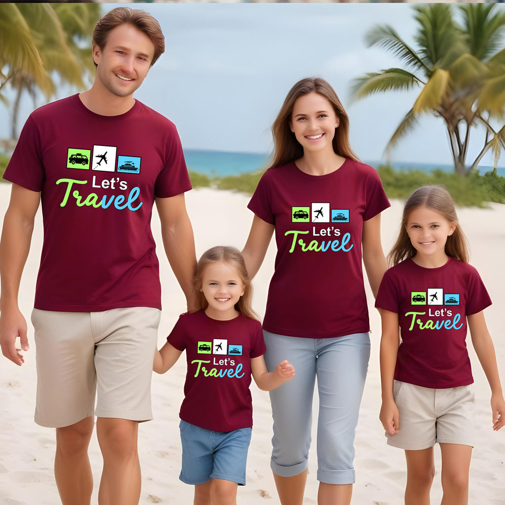 Family of four wearing matching maroon t-shirts with 'Let's Travel' design on a beach.