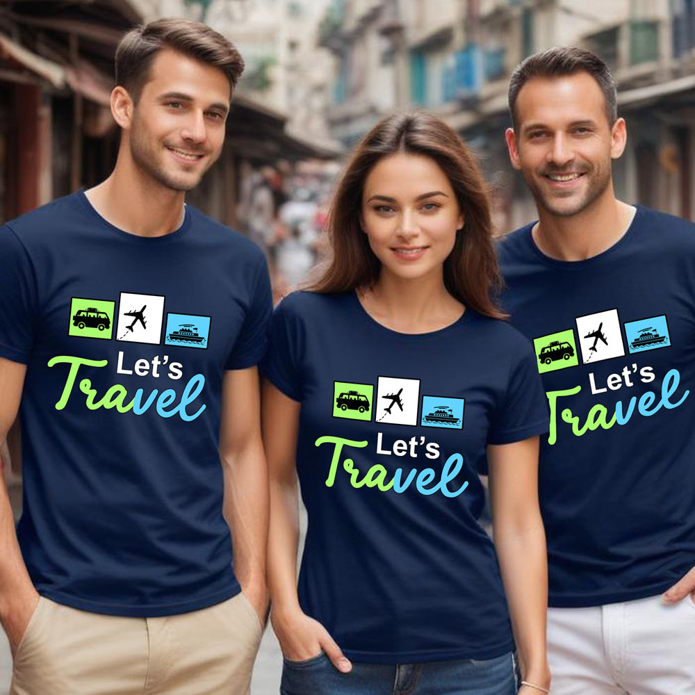 Three people wearing navy blue t-shirts with 'Let's Travel' text and graphics on a street background.