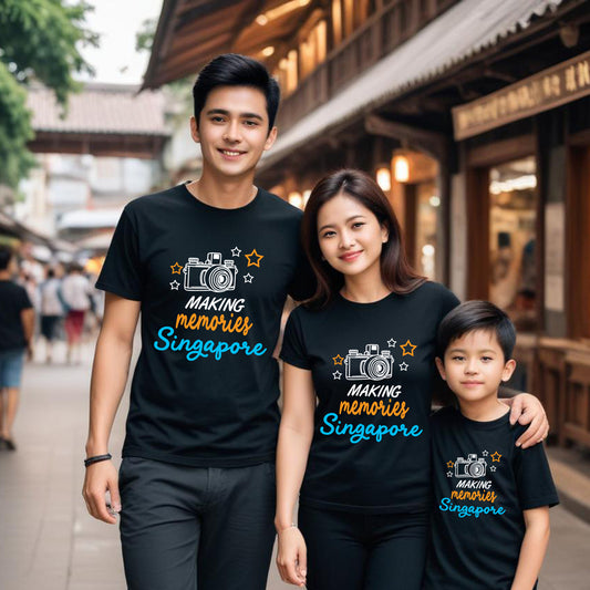 Family of three wearing matching t-shirts with 'Making Memories Singapore' text and camera graphic.