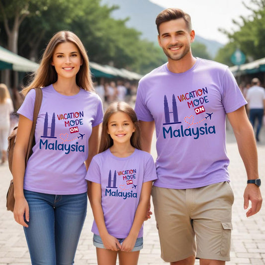 Family of three wearing matching purple t-shirts with 'Vacation Mode ON Malaysia' text.