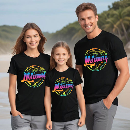 Family of Three wearing Black Tshirts with a design of "Miami Making Memories" in the beach.