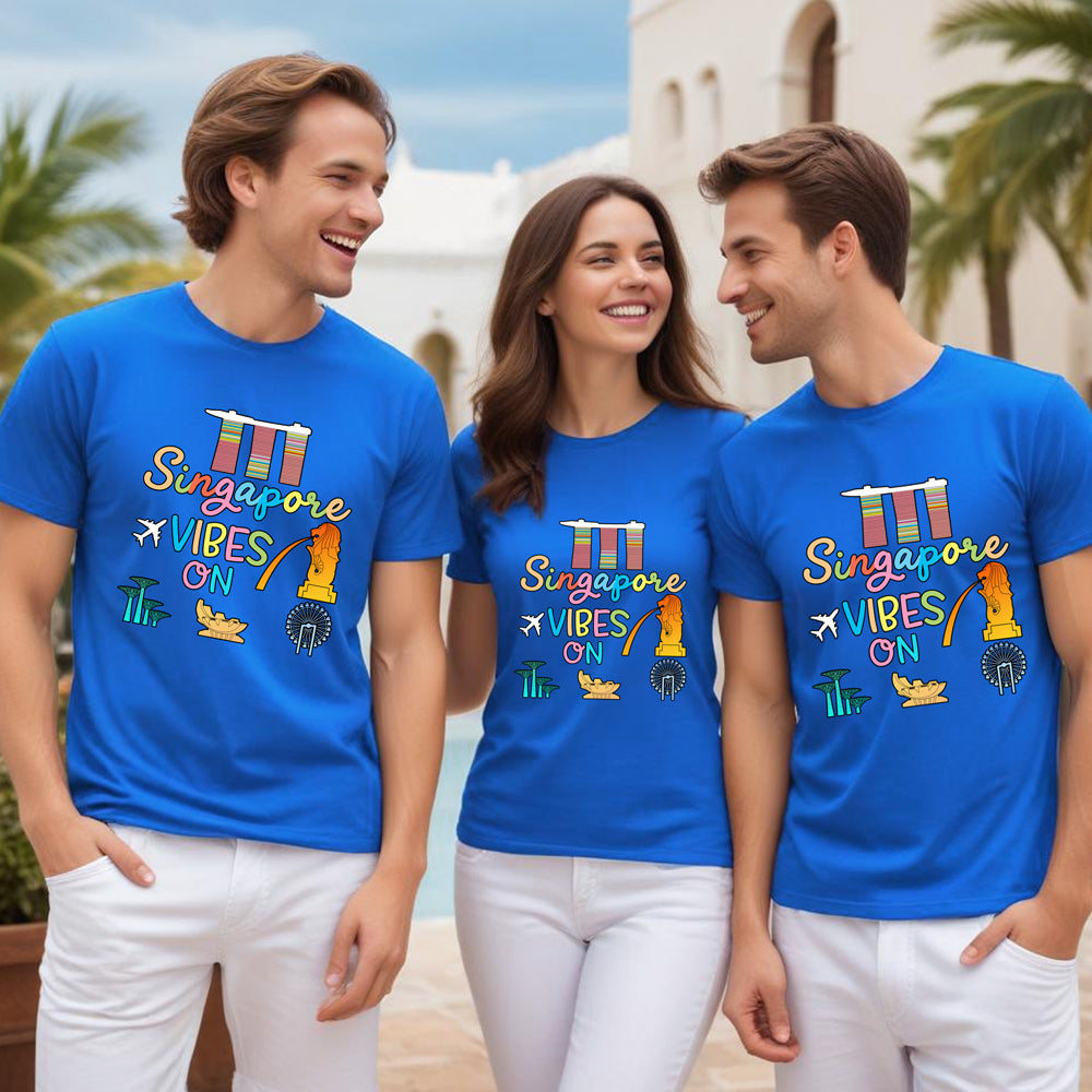 Three people wearing blue t-shirts with 'Singapore Vibes On' text and graphics.