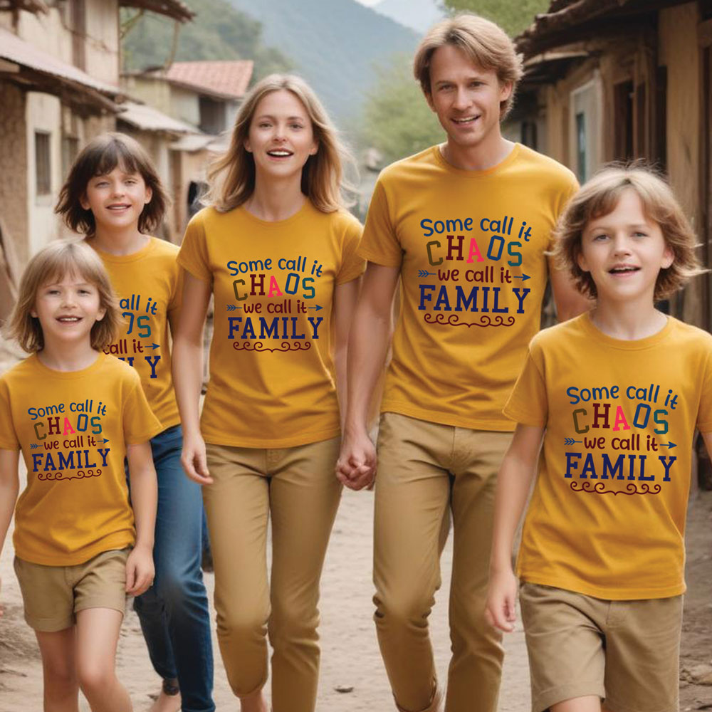 Family wearing matching yellow t-shirts with a humorous family quote in a rustic village setting.