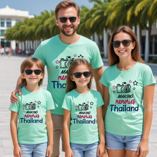 Family of four wearing matching teal t-shirts with 'Making Memories Thailand' text and camera graphics.