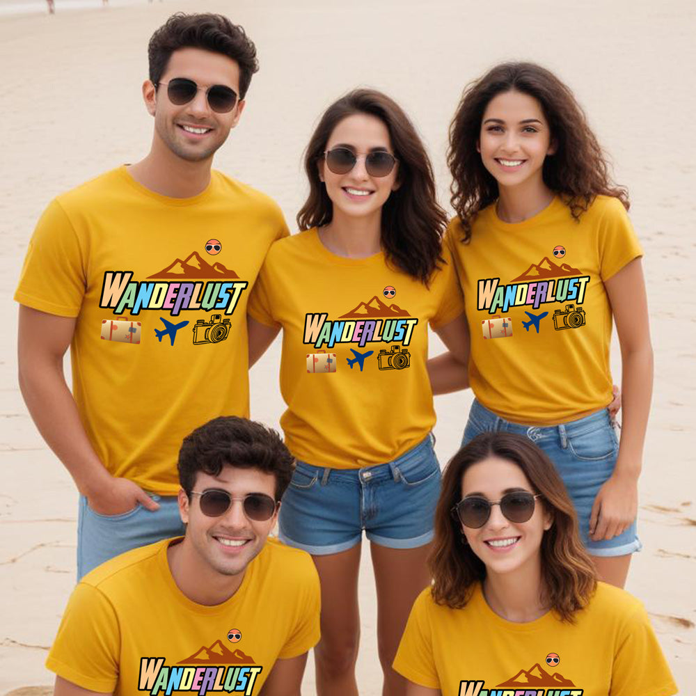 Five people wearing yellow t-shirts with 'Wanderlust' design on a beach.